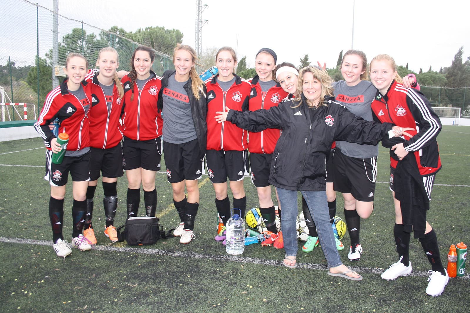 Happy youth girls soccer team after match on Spain tour